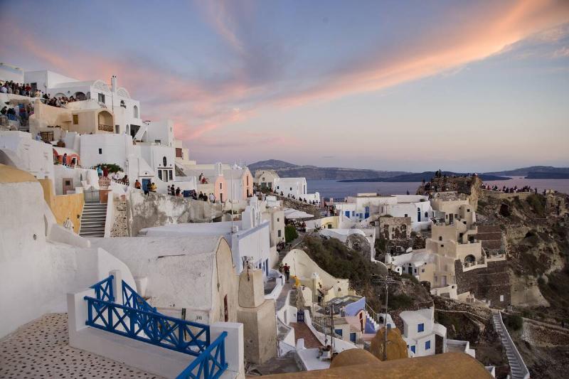 Greece - Santorini - Tourists watching the sunset in Oia Greece - Santorini - Tourists watching the sunset in Oia
