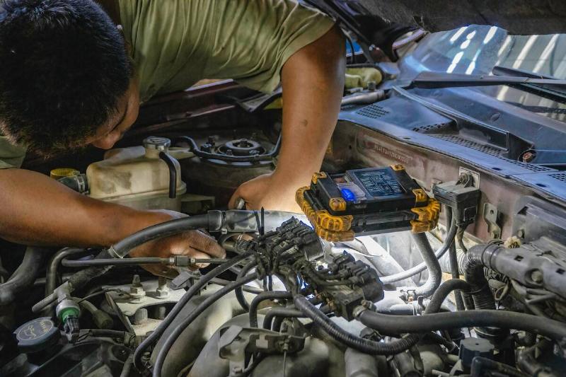 A mechanic from a local car repair shop seen testing the... A mechanic from a local car repair shop seen testing the...