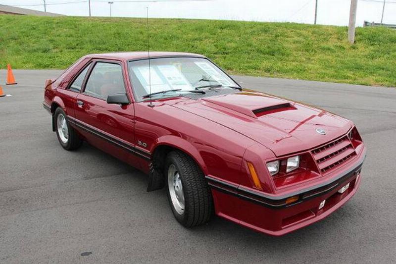1982 Ford Mustang GT parked on concrete, near a grassy area