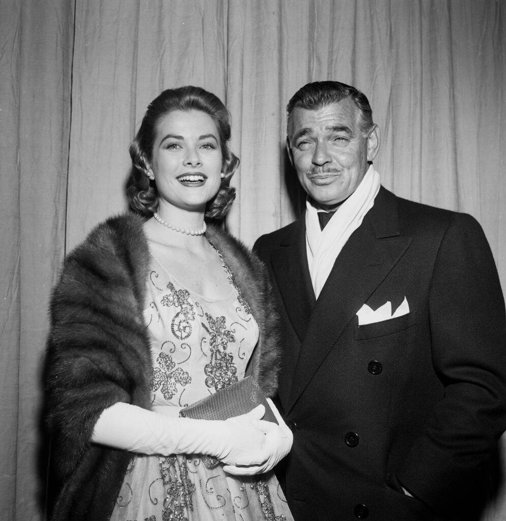 Grace Kelly and Clark Gable standing together in fancy clothing