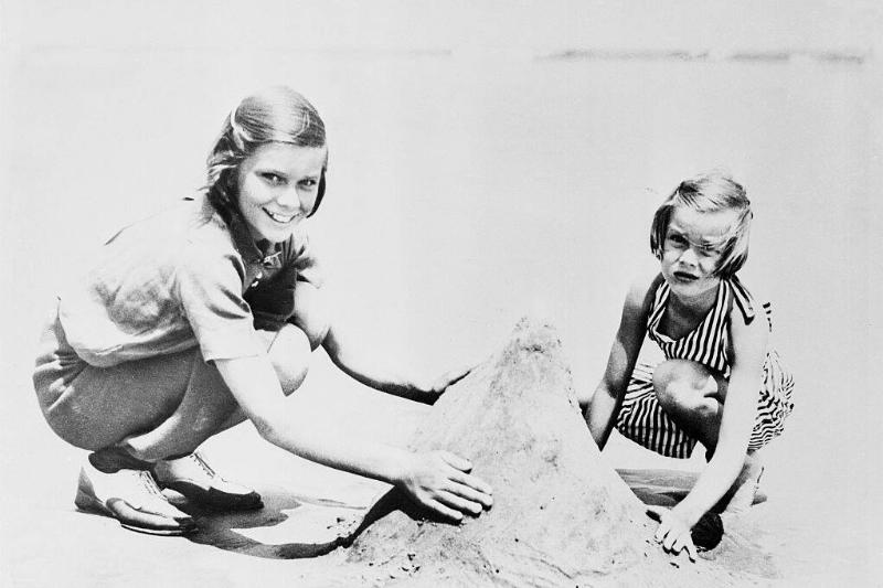 Grace and Peggie Kelly building a mountain in the sand