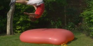 6 foot water balloon explodes in slow motion.