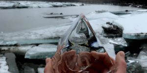Crystal clear ice chunk in Alaska river bed