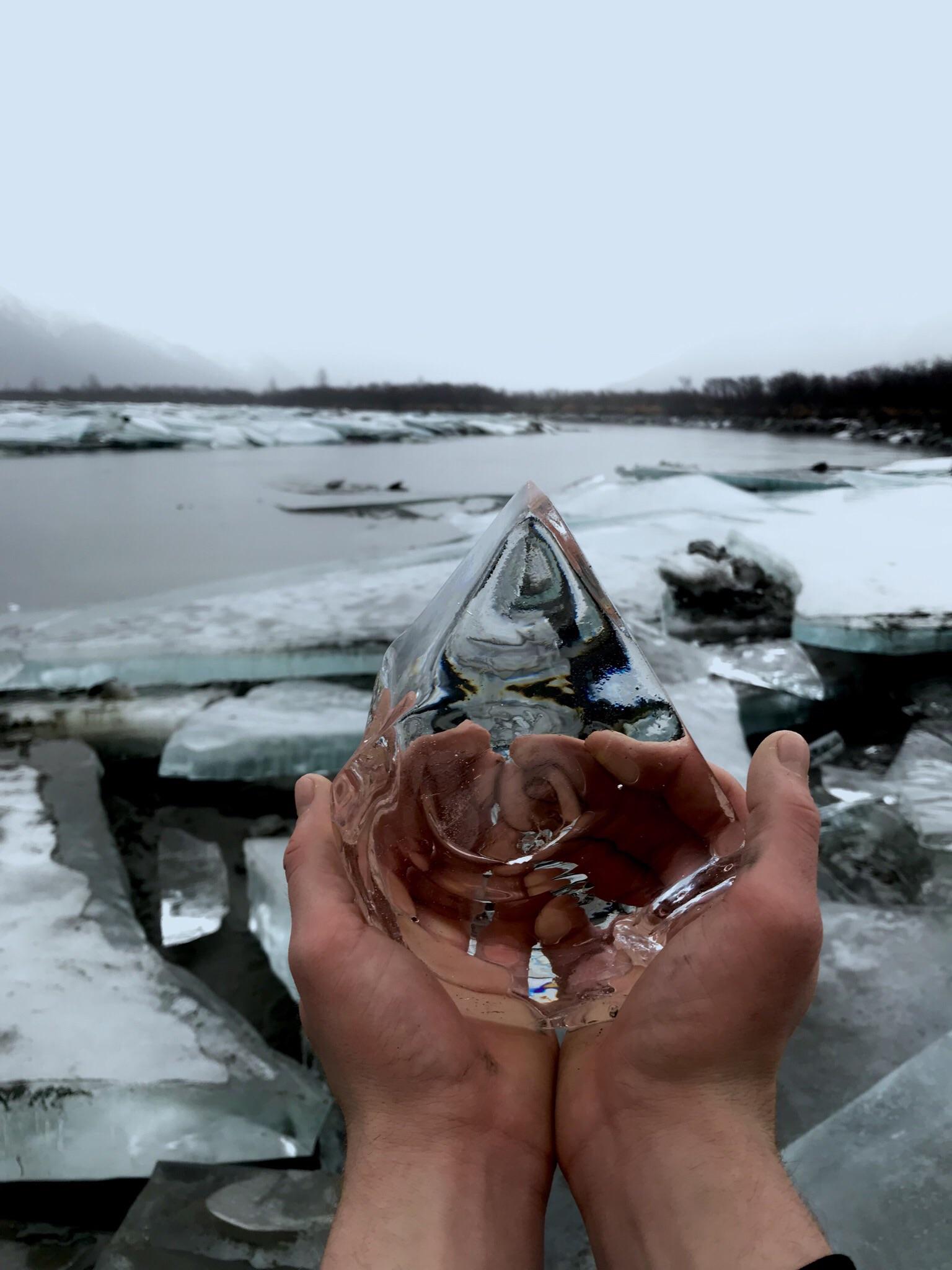 Crystal clear ice chunk in Alaska river bed