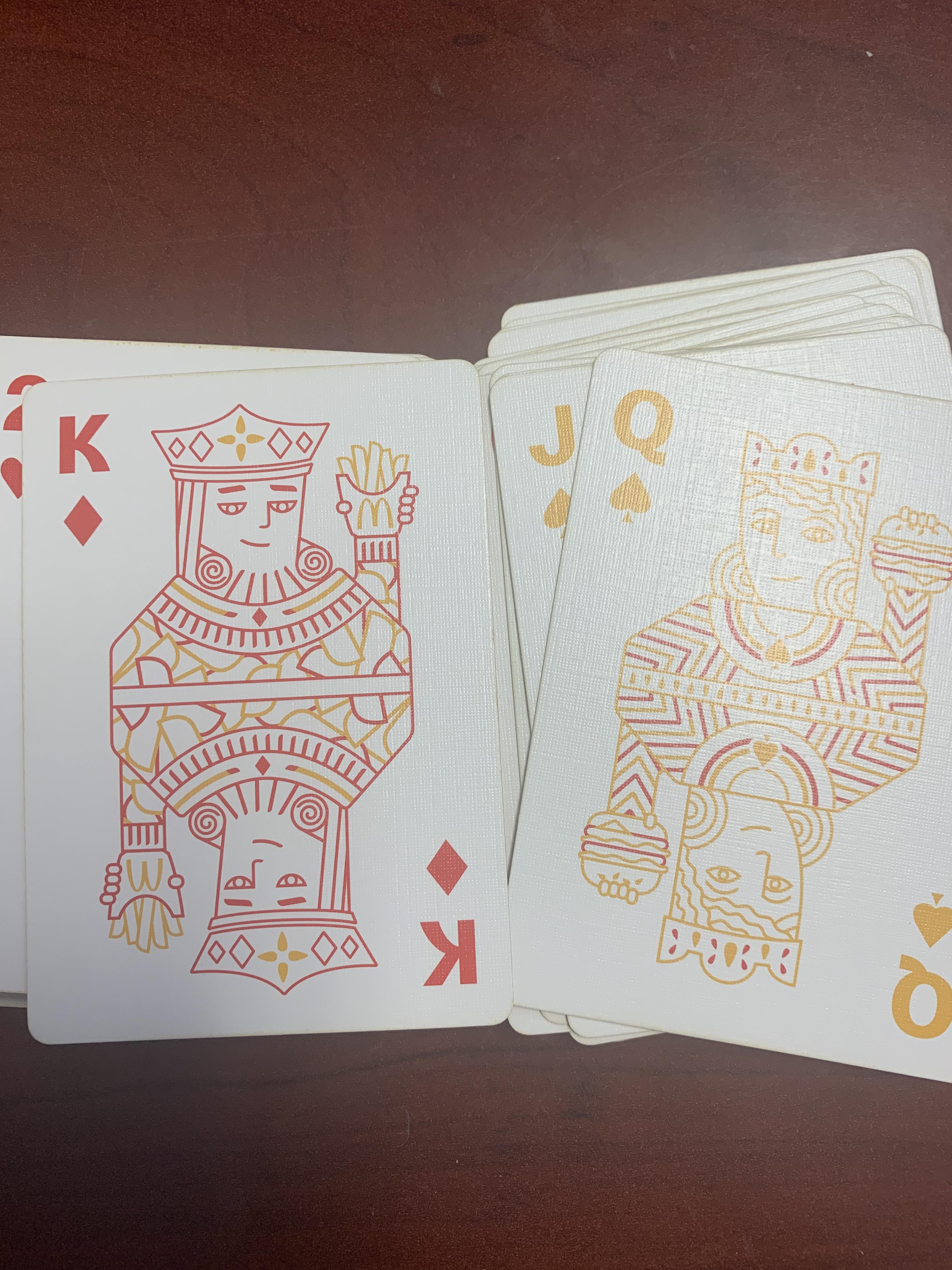 McDonald's themed deck has the queen holding the burger... for reasons.