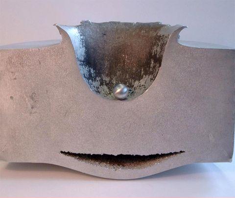 Result of a steel ball, moving at 4.2 miles/second, impacting a 12 inch thick steel block