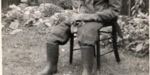 Just a dog dressed as a man with his pet cat.