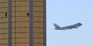 Air Force One departs Las Vegas past the broken windows on the Mandalay Bay hotel
