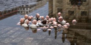 Sculpture by street artist Isaac Cordal, titled "Politicians Debating Global Warming"
