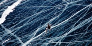 Riding a horse across a frozen lake in the Pamir mountains.