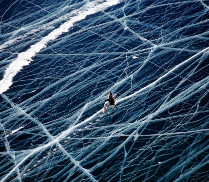 Riding a horse across a frozen lake in the Pamir mountains.