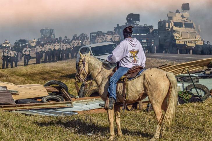 Police facing a pipeline protester in North Dakota