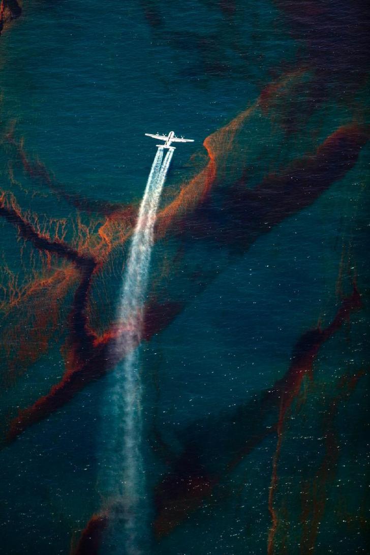 Spraying dispersant over an oil spill