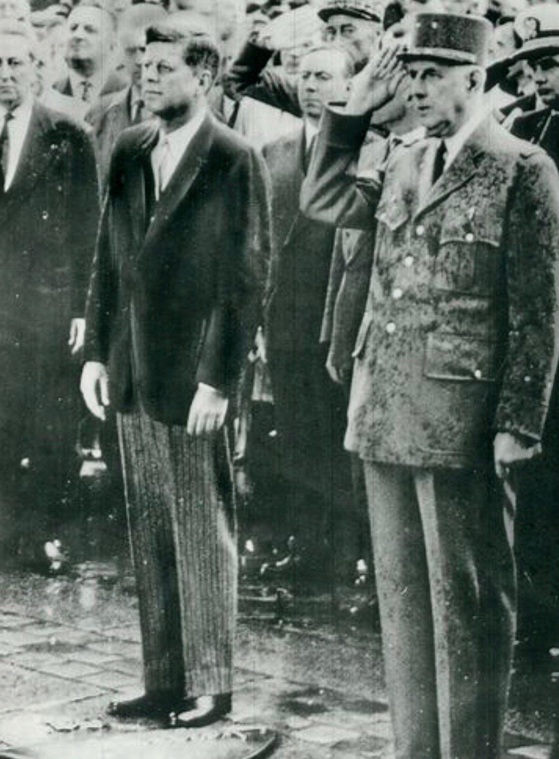 In the Paris rain, May 1961, JFK and de Gaulle honor soldiers who gave their lives: