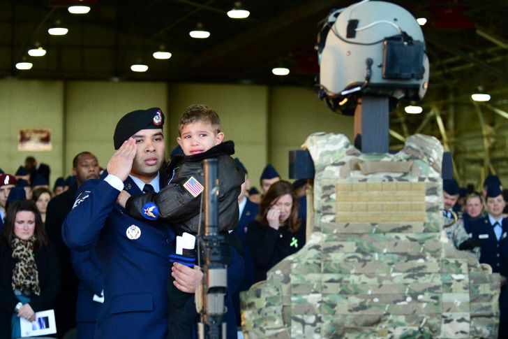 Child says final goodbye to his mother after the USAF Pavehawk crash in England last week.
