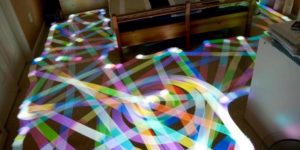 Long exposure of a roomba vacuum with color-changing light on top