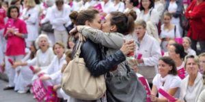 Two women kissing in front of an anti gay marriage protest in Marseille, France. ‘˜Le baiser de Marseille’.