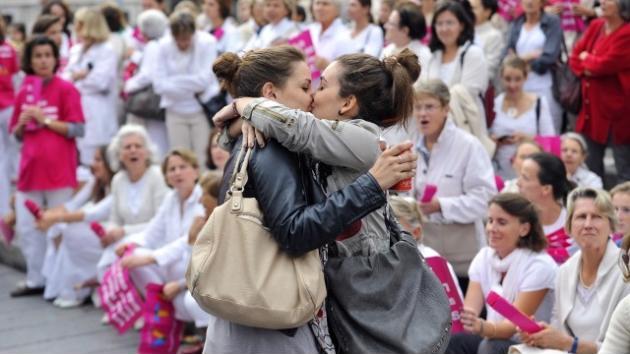 Two women kissing in front of an anti gay marriage protest in Marseille, France. '˜Le baiser de Marseille'.