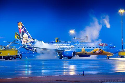 Airport ground crews de-icing a Frozen plane