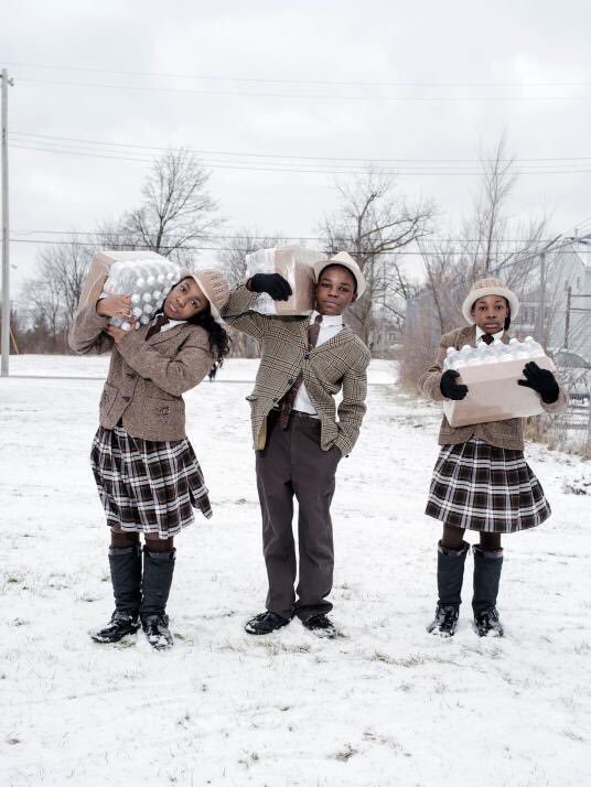 America in 2016. 3 siblings picking up their daily allowance of bottled water from the Fire Dept in Flint, MI.