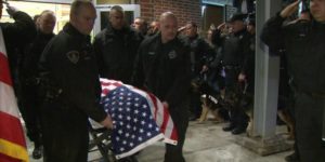 Slain K-9 officer being led out of veterinary hospital in coffin. His name was Rocco.