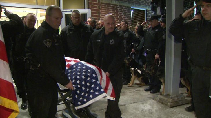 Slain K-9 officer being led out of veterinary hospital in coffin. His name was Rocco.