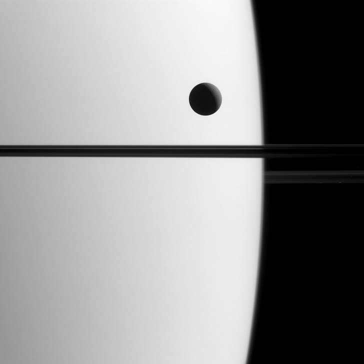 Saturn's Moon Dione Crossing the Planet
