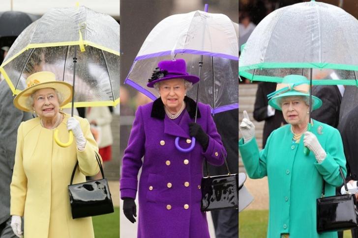 Queen Elizabeth carries her own umbrella, in style.