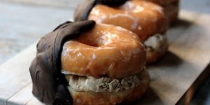 Glazed donuts stuffed with chocolate chip cookie dough hand dipped in chocolate.