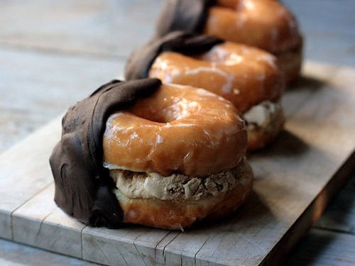 Glazed donuts stuffed with chocolate chip cookie dough hand dipped in chocolate.