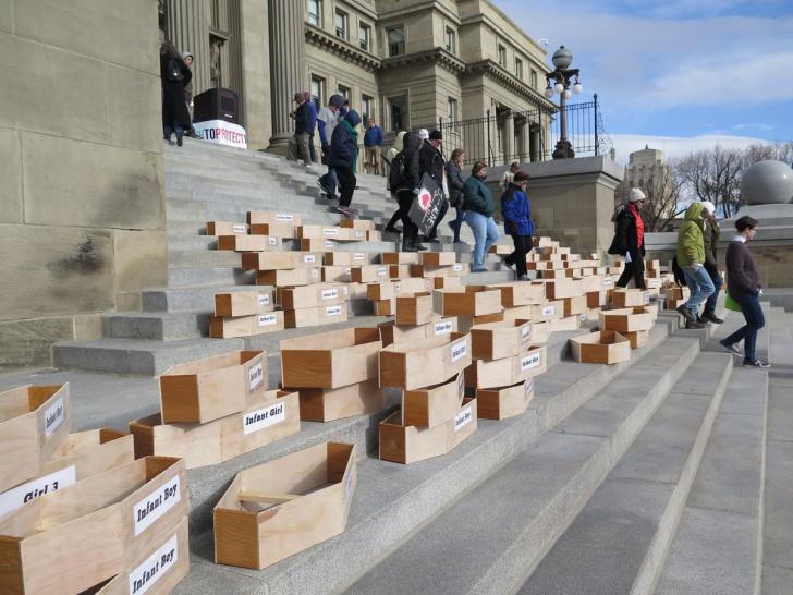 Idaho residents put coffins on the steps of the capitol to protest the faith-healing exemption which allows parents to deny children medical care.