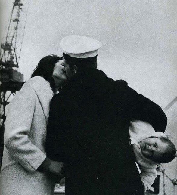 Meeting his baby for the first time after 14 months at sea, circa 1942's.