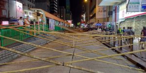 Protesters in HK set up bamboo road blocks.