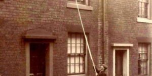 Before alarm clocks were affordable, ‘knocker-ups’ were used to wake people early in the morning. UK, around 1900