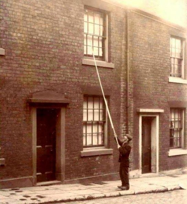 Before alarm clocks were affordable, 'knocker-ups' were used to wake people early in the morning. UK, around 1900