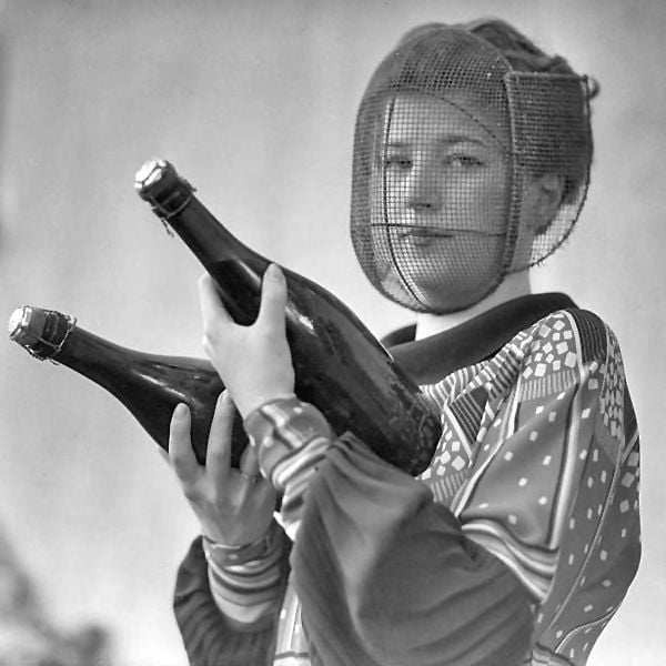 A champagne inspector wearing a special mask to protect against accidental discharge, circa 1920.