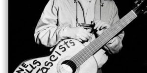 Woody Guthrie and his guitar, roundabout 1941’s.