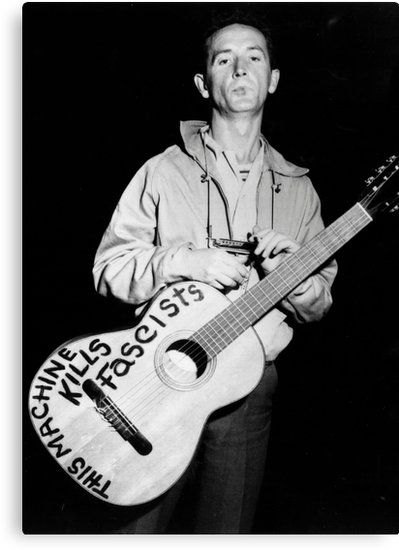 Woody Guthrie and his guitar, roundabout 1941's.