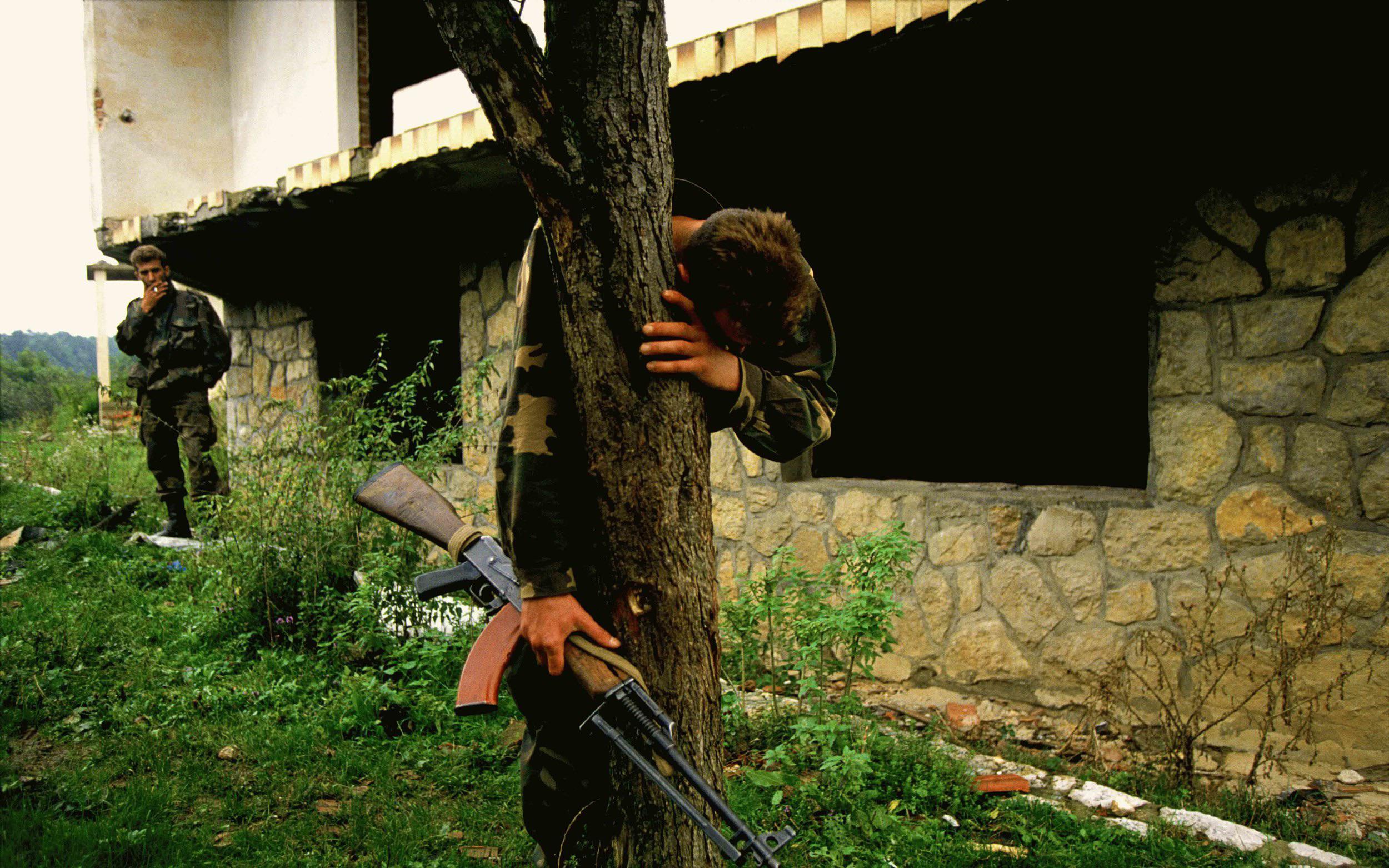 A Bosnian Soldier hugs tree and cries. War is Hell.