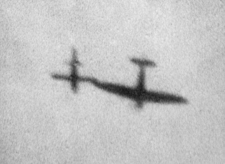 A supermarine spitfire using the tip of it's wing to nudge a V-1 rocket off course