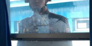 North Korean soldier stares through the window into the conference blue building run by the UN in the DMZ. Photo by Congressman Jason Chaffetz.
