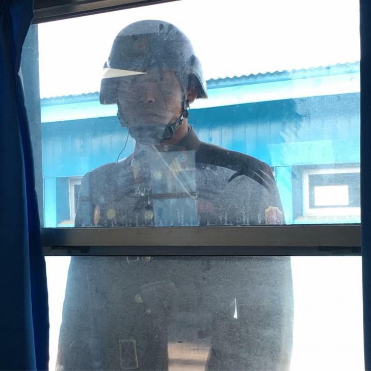 North Korean soldier stares through the window into the conference blue building run by the UN in the DMZ. Photo by Congressman Jason Chaffetz.