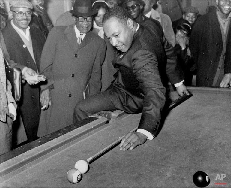 Martin Luther King Jr. prepping a behind-the-back shot at a pool hall in Chicago circa 1966