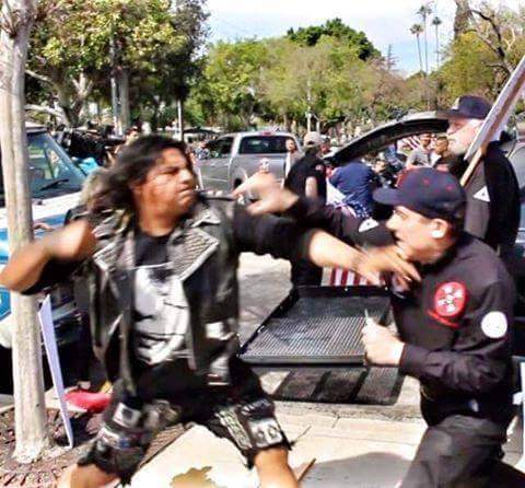 A punk about to knockout a klan member.