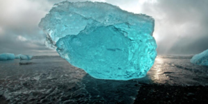 Amazing Blue Iceberg washed up on the volcanic beaches of Iceland