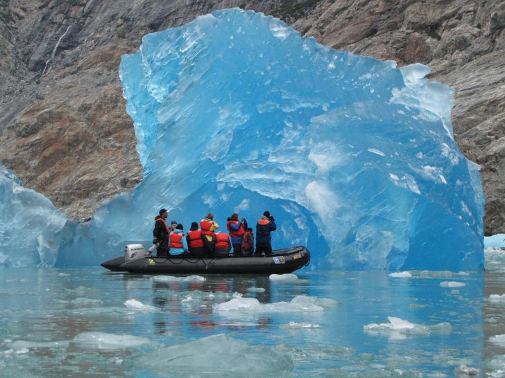 The Brilliant Blue of a Rolling Iceberg in Alaska