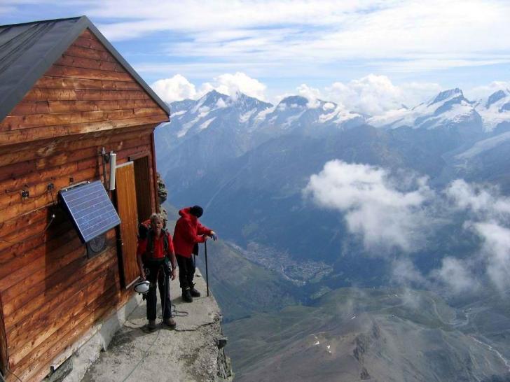 A mountain dwelling near a thousand foot cliff