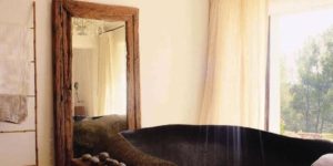 Bathing in style with a granite boulder tub and chandelier shower head