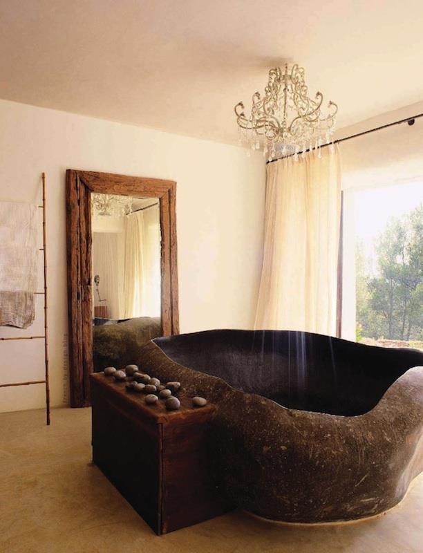 Bathing in style with a granite boulder tub and chandelier shower head