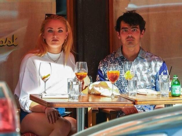 Sophie Turner and Joe Jonas staring at paparazzi.